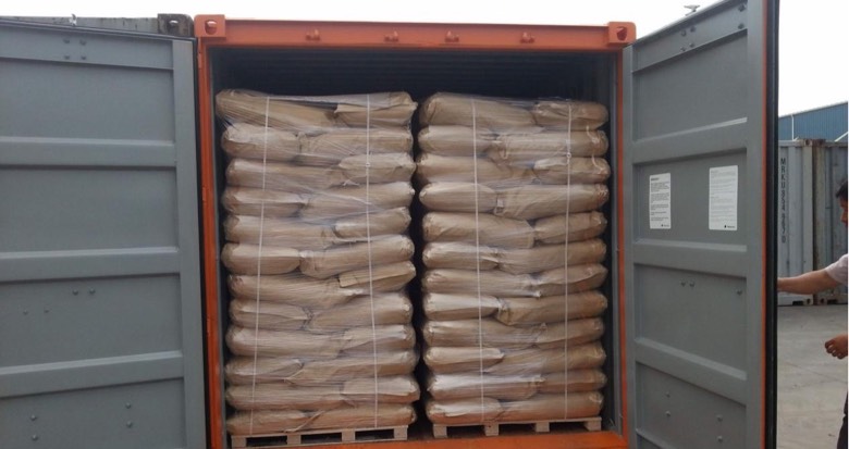Palletized kraft paper bags secured inside a shipping container