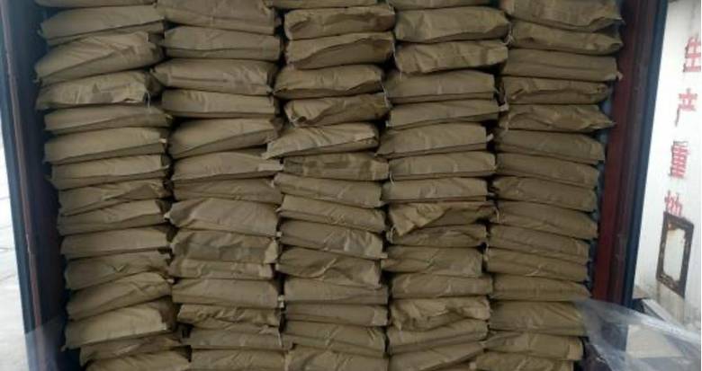 Stacked kraft paper chemical bags inside a dry freight container during load planning