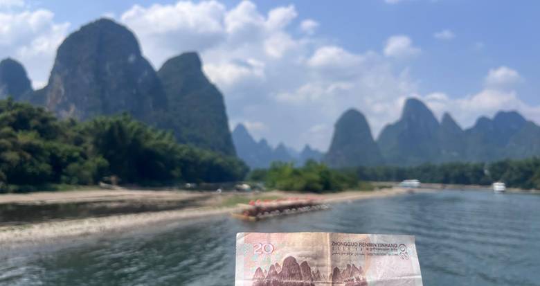 Li River scenery in Guilin with karst peaks and a 20 yuan banknote in the foreground
