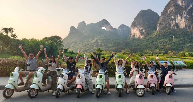 SINOCMC team members with scooters during a ride through Yangshuo's Ten-Mile Gallery