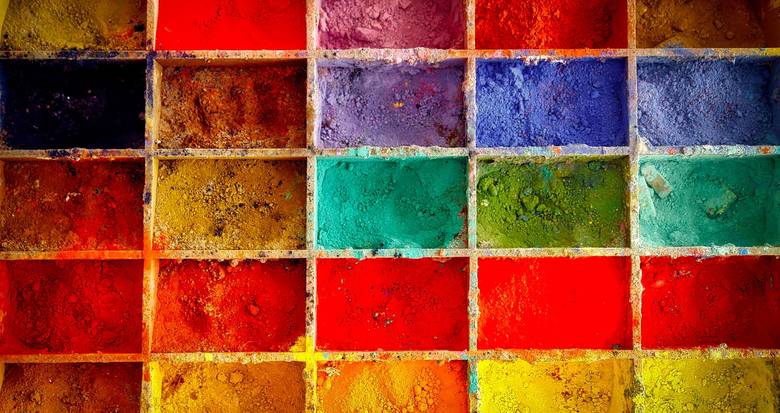 Rows of dry pigment colors illustrating the need to hold pigment selection constant in a paint trial