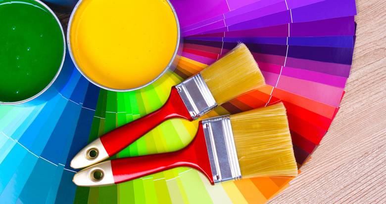 Open paint samples, color cards and brushes prepared for a water based paint CMC trial